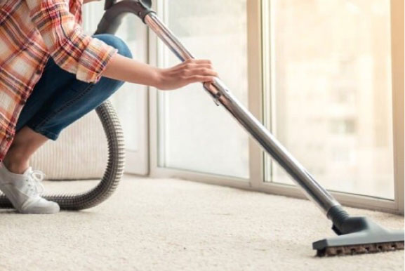 Lady cleaning carpet | Echo Flooring Gallery